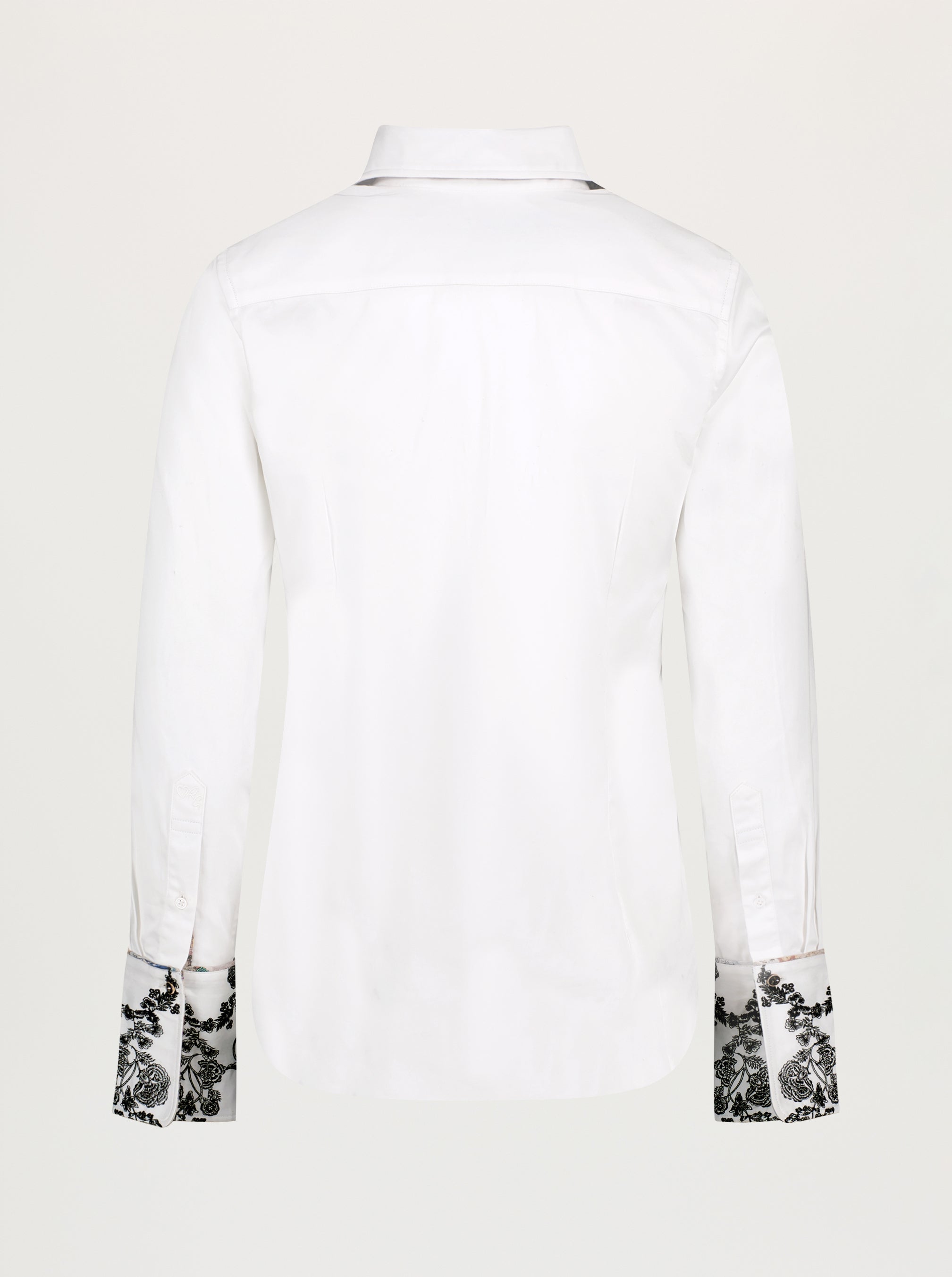 White dress shirt with floral cuffs on a white background