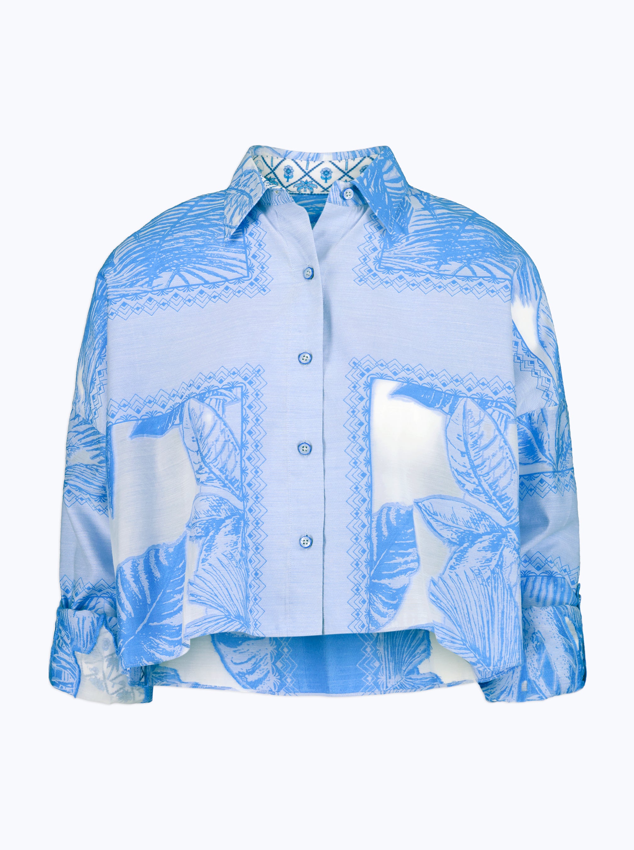 Blue and white leaf patterned shirt on a white background