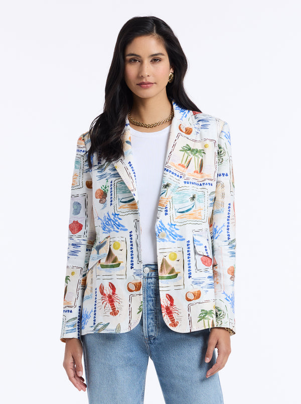 Woman wearing a colorful tropical patterned jacket on a white background