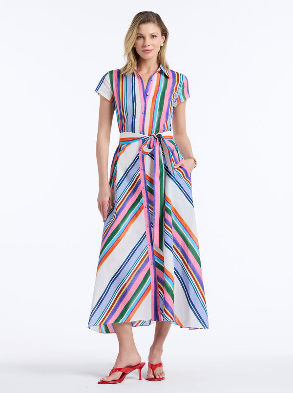Woman wearing a colorful striped dress on a white background