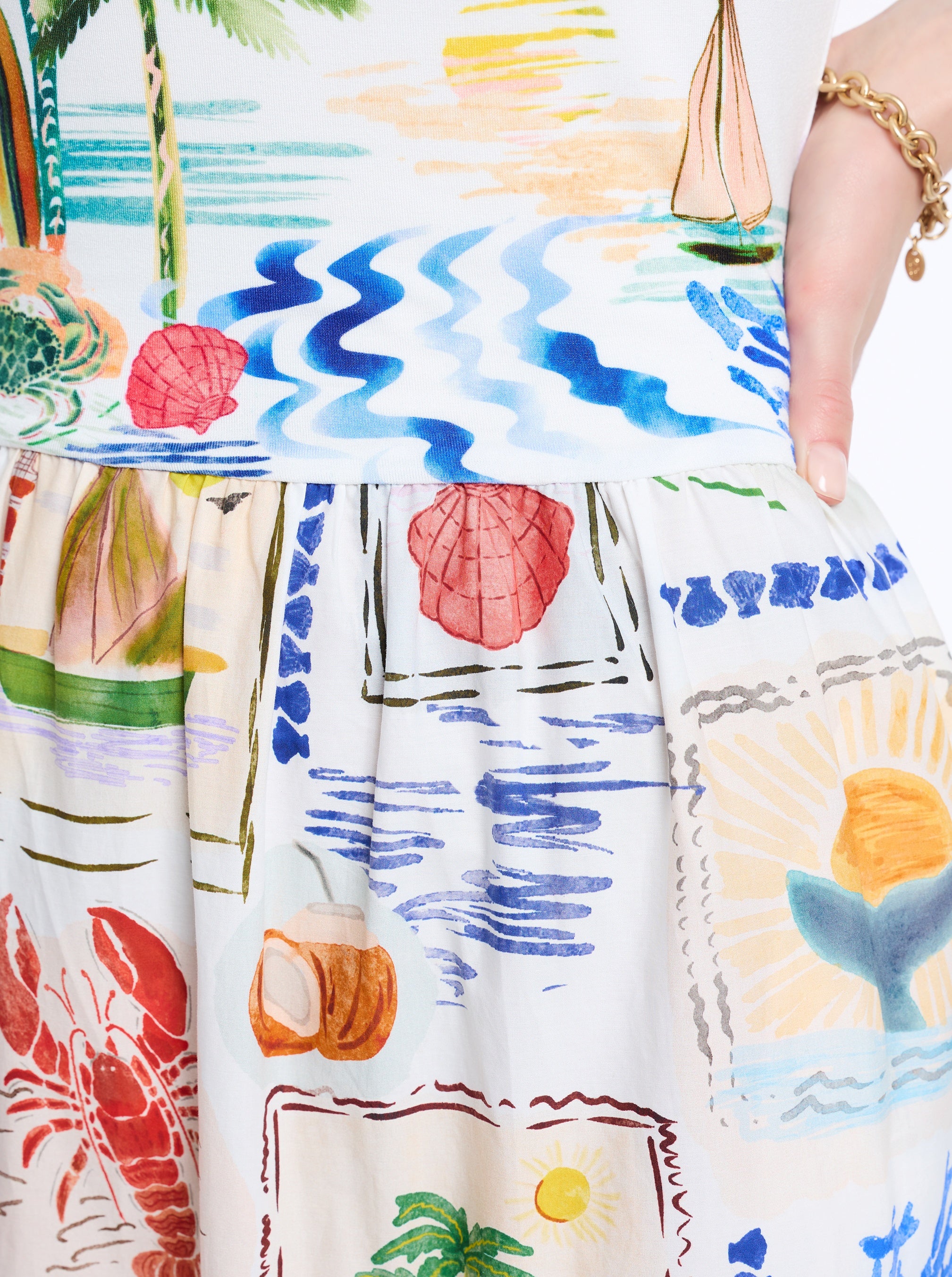 Colorful beach-themed fabric with mermaid, palm trees, and seashells.