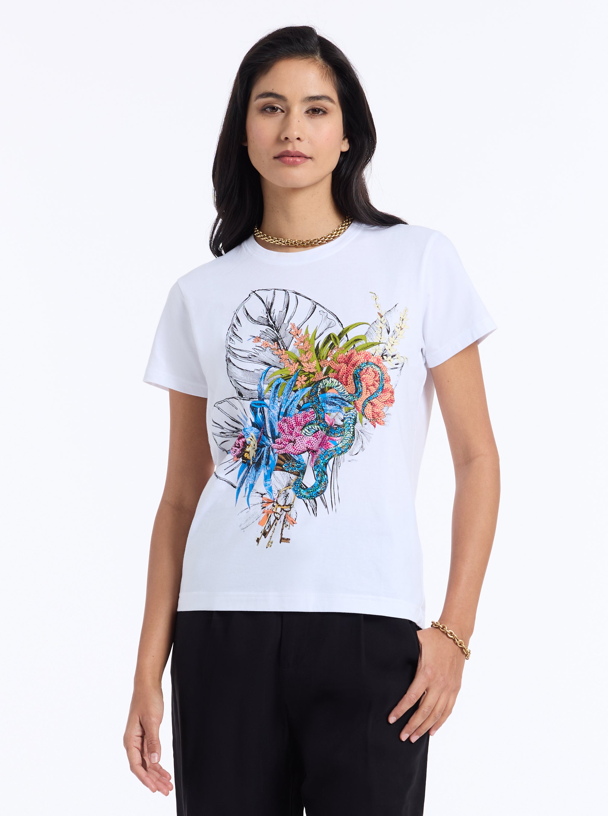 Woman wearing a white t-shirt with a colorful graphic design on a white background