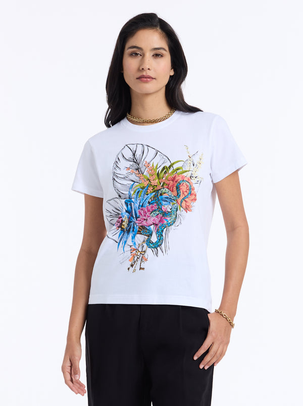 Woman wearing a white t-shirt with a colorful graphic design on a white background