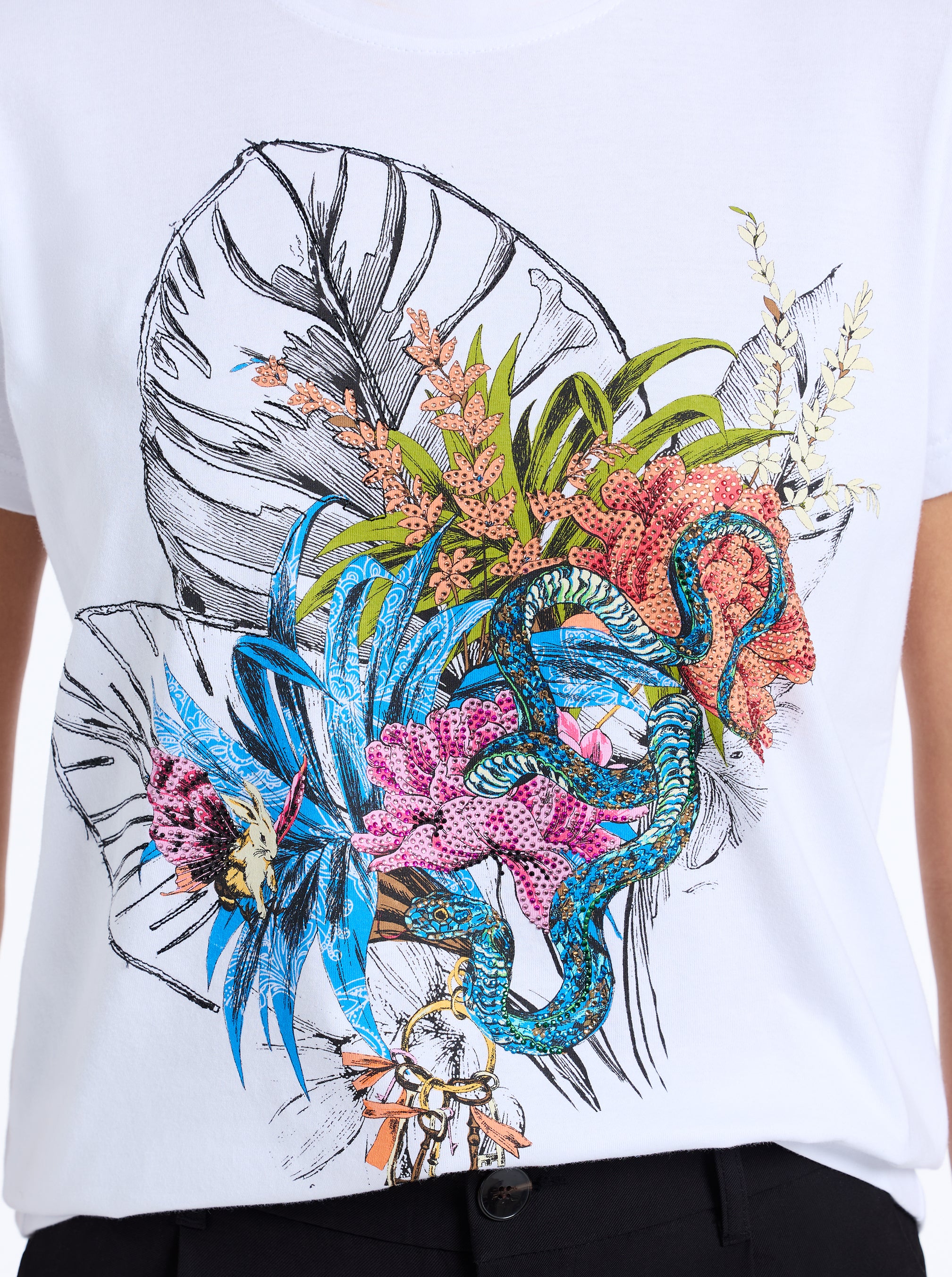 White t-shirt with a colorful leaf, snake and coral design.