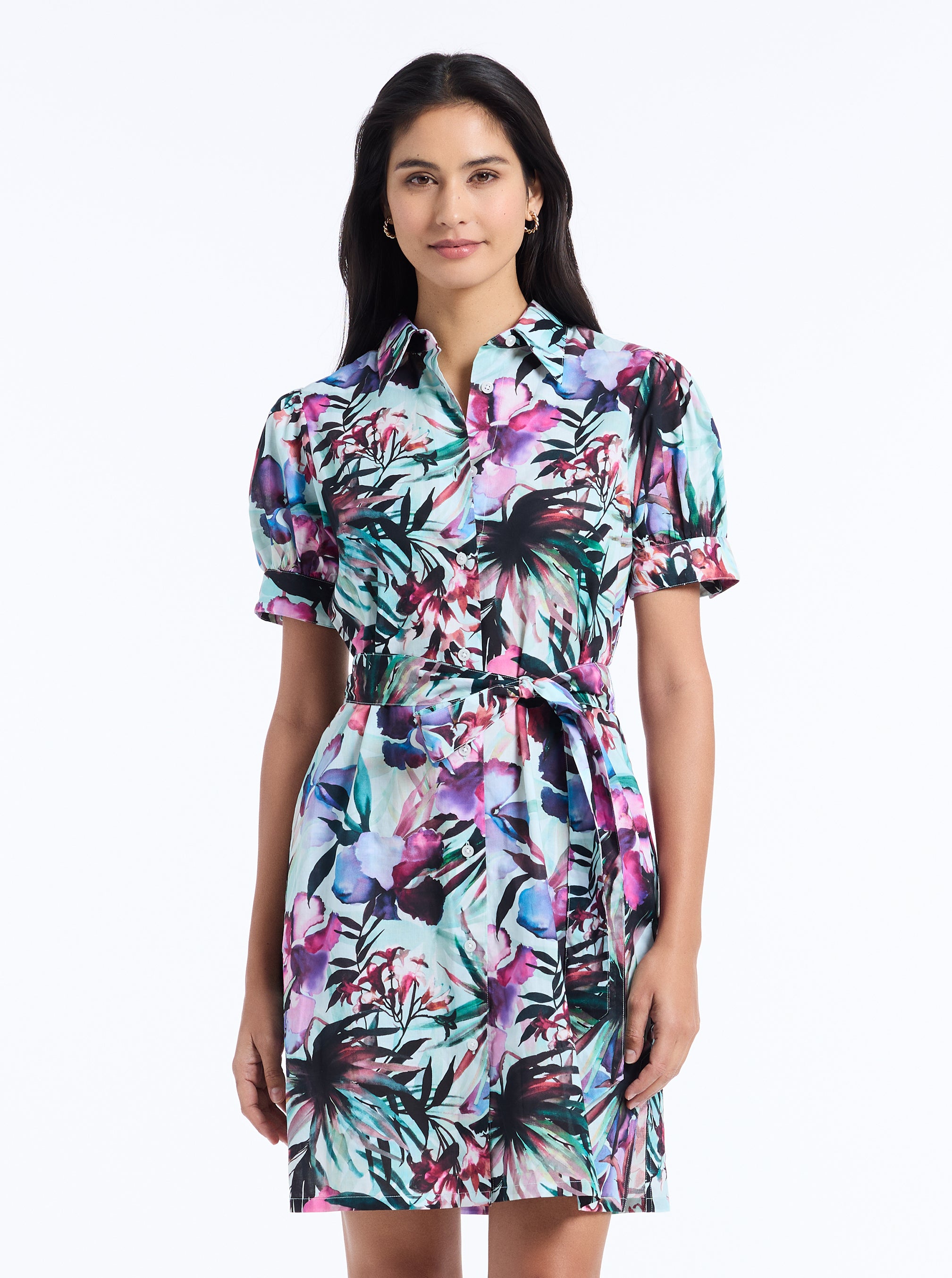 Woman wearing a colorful floral dress on a white background