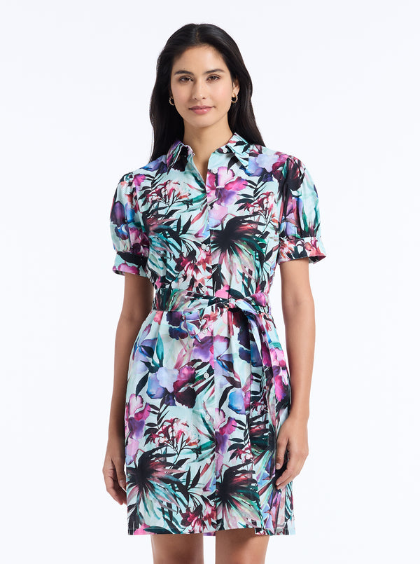 Woman wearing a colorful floral dress on a white background